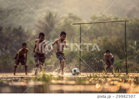 Boy kicking a soccer ball 29982507