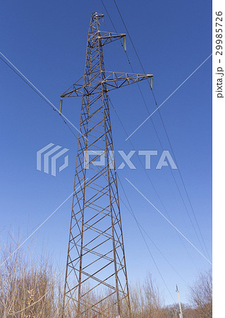 Concrete electric pole with wires against the sky 29985726
