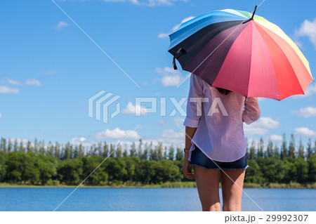 Woman holding an umbrella. Woman holding an umbrella. 29992307