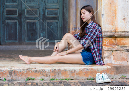 woman sitting on the cement floor. 29993283