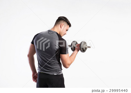 Fitness man holding dumbbell, working out, studio Fitness man holding dumbbell, working out, studio 29995440