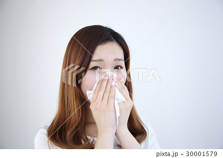 風邪 花粉症 女性 ティッシュ 咳 飛沫 飛まつの写真素材