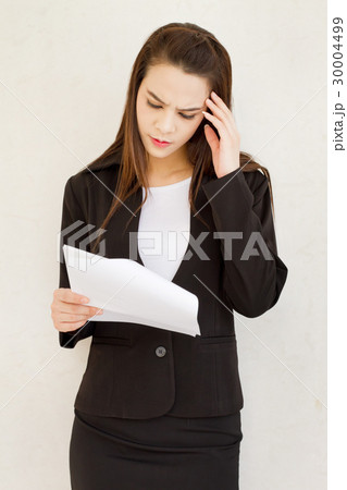 frustrated business woman reading the document 30004499