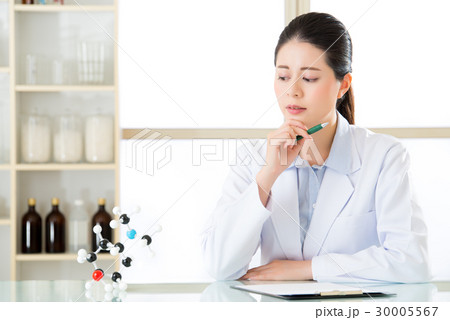 asian female chemist try to figure out Chemical 30005567
