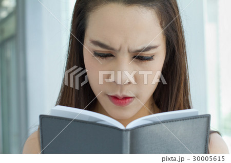 woman looking at notebook with stress woman looking at notebook with stress 30005615