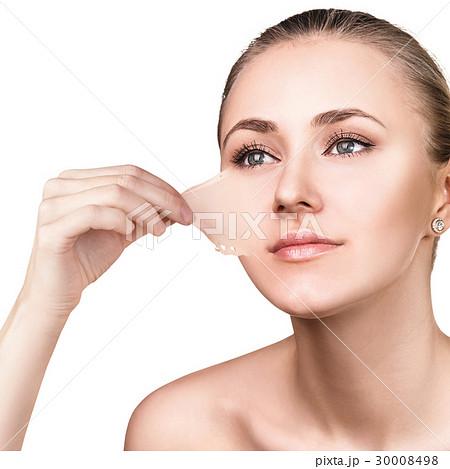 Woman remove her old dry skin from face. 30008498