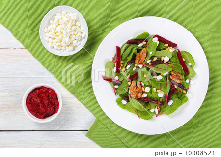 caramelized walnuts salad on white plate 30008521