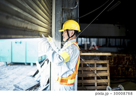 建設現場 シャッターを開ける作業員の写真素材