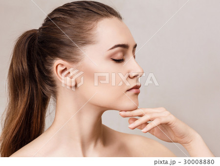 Young woman's face with clean skin. 30008880