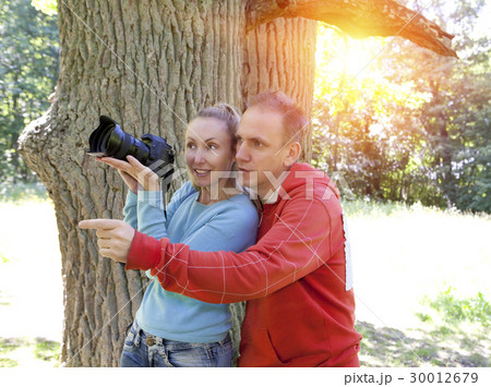 man and  woman near an oak in summer  day show to  30012679