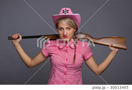 Attractive cawbow girl with shot gun over back 30013405
