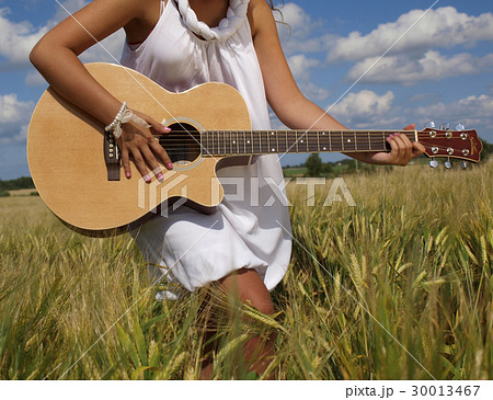 Country girl sitting with guitar 30013467