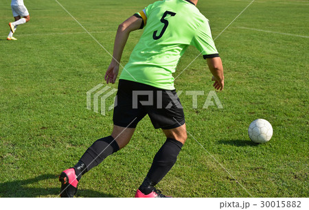 Soccer player runs with a ball 30015882