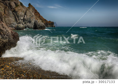 Rocky seashore and waves on a sunny day 30017133