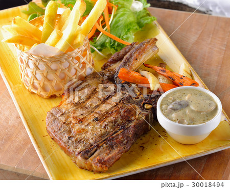 Pork chop steak on the table. 30018494