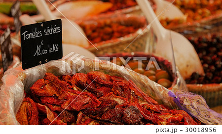 Delicious dry tomatoes at the market. 30018956