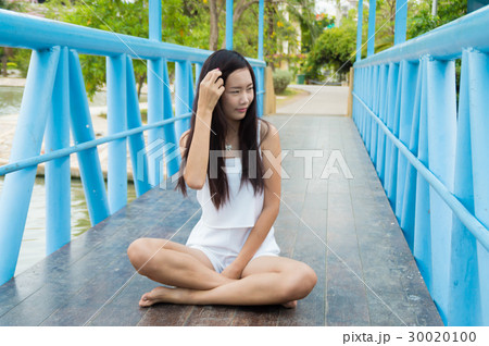 Attractive young woman enjoying her time outside 30020100