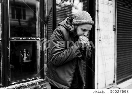 Guy Blowing his Hands in Cold Outdoor Guy Blowing his Hands in Cold Outdoor 30027698