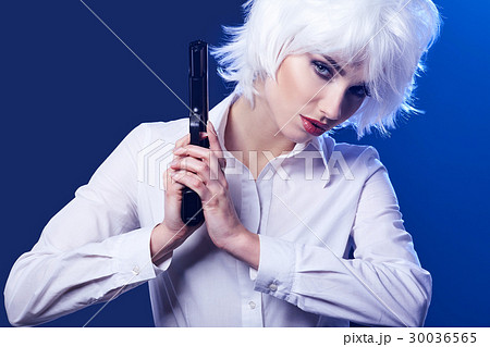 beautiful sexy girl holding gun . blue background beautiful sexy girl holding gun . blue background 30036565