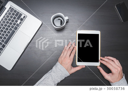 Male hands using Tablet on the desk 30038736