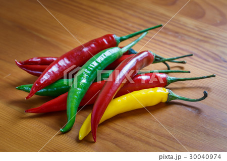 Hot chili peppers on a wooden table 30040974