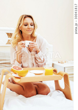 young beauty blond woman having breakfast in bed young beauty blond woman having breakfast in bed 30041817