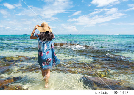 Girl standing in the sea wearing blue dress. 30044121