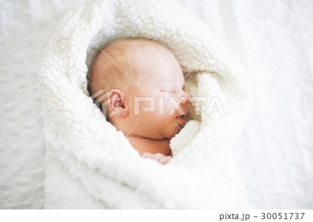 Baby boy (2-5 months) sleeping in white blanket Baby boy (2-5 months) sleeping in white blanket 30051737