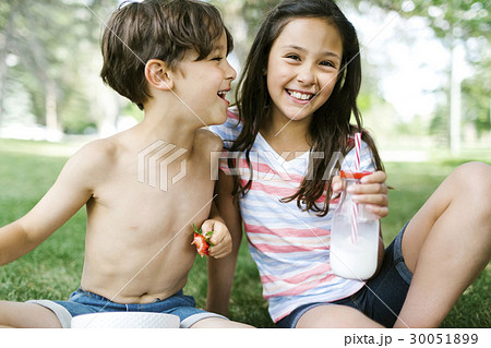 Portrait of sister ( 10-11 ) and brother (6-7 ) on picnic 30051899