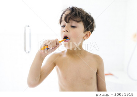 Portrait of boy (6-7 ) brushing teeth 30051919