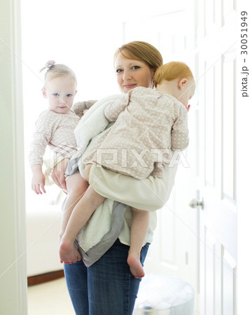 Portrait of mother embracing daughters ( 12-17 months ) Portrait of mother embracing daughters ( 12-17 months ) 30051949