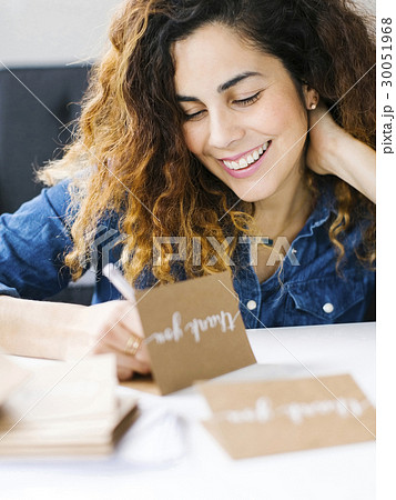 Woman handwriting in living room Woman handwriting in living room 30051968