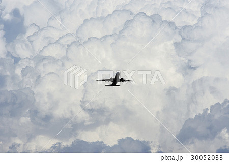 Airplane in sky with clouds in background 30052033