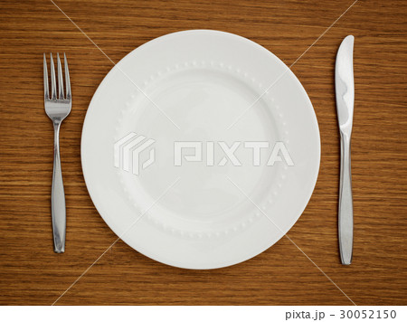 Studio shot of white plate with fork and knife Studio shot of white plate with fork and knife 30052150