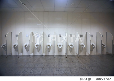 Urinals in a porcelain toilet 30054782