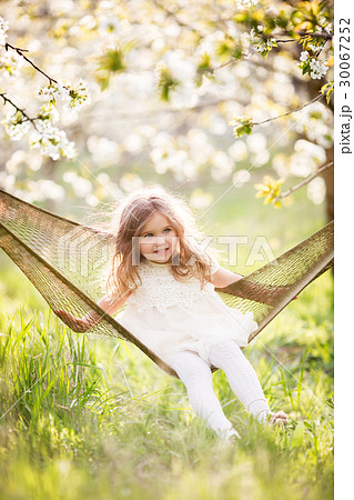 Baby girl in hammock in spring garden 30067252