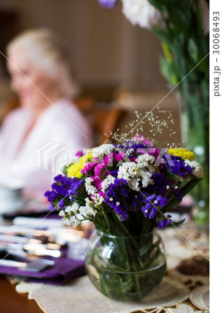 Bowl with field flowers stands on table before  30068493
