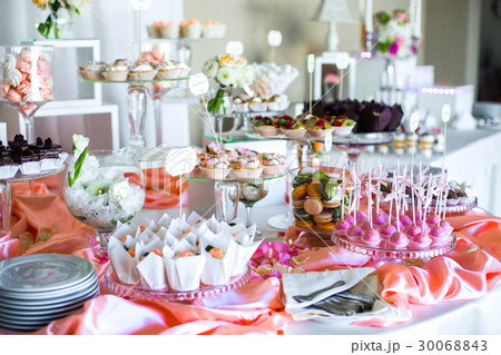 Table with delicious sweets covered with pink silk Table with delicious sweets covered with pink silk 30068843