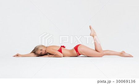 Girl with perfect body in red underwear on white Girl with perfect body in red underwear on white 30069136