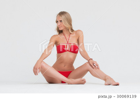 Girl with perfect body in red underwear on white Girl with perfect body in red underwear on white 30069139