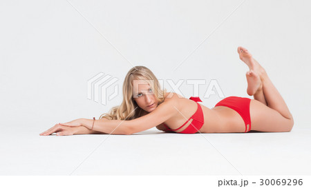 Girl with perfect body in red underwear on white 30069296