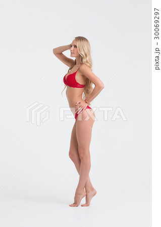 Girl with perfect body in red underwear on white 30069297