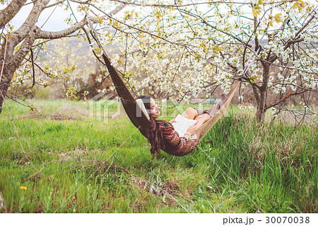 Woman is relaxing in hammock on the nature 30070038