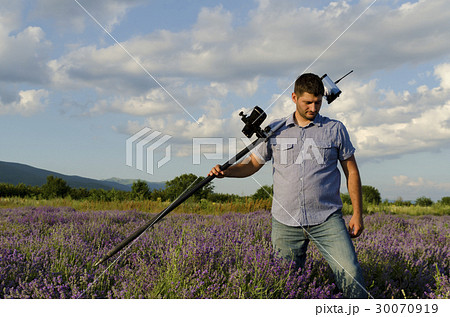Land surveyor walking in a lavender field 30070919