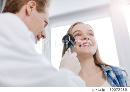 Elderly specialist exploring patient skin at work 30072936