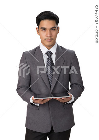 businessman wearing gray suit using digital tablet businessman wearing gray suit using digital tablet 30074485