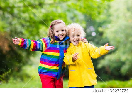 Kids play in rain and puddle in autumn Kids play in rain and puddle in autumn 30079726