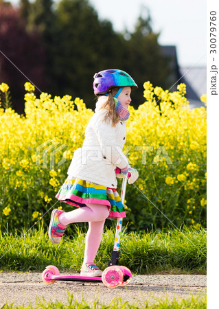 Child riding schooter on way to school Child riding schooter on way to school 30079760