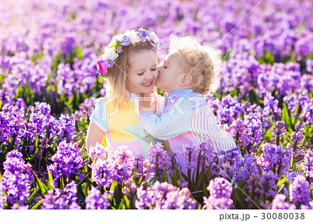 Kids play in blooming garden with hyacinth flowers 30080038