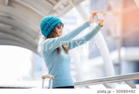 woman taking selfie with travel bags woman taking selfie with travel bags 30080492